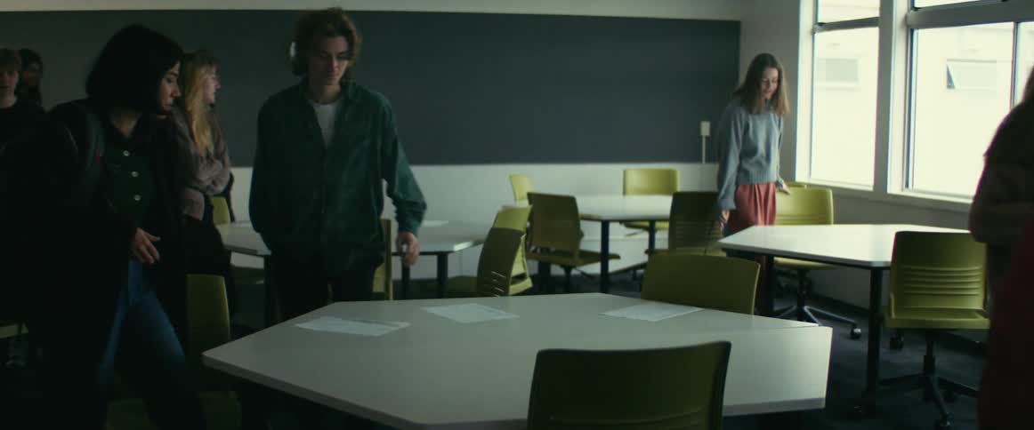 A group of students enter the classroom