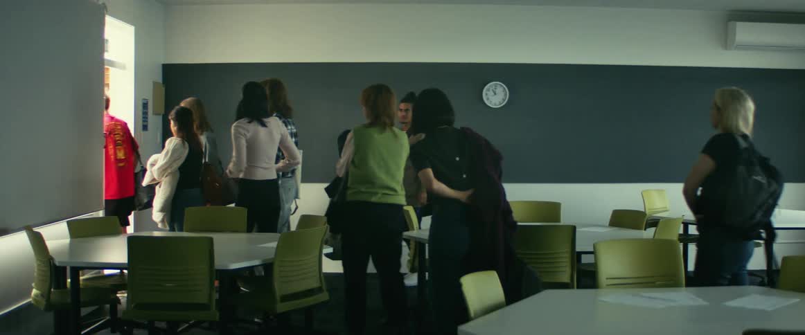 Group of students walking out of the classroom after class