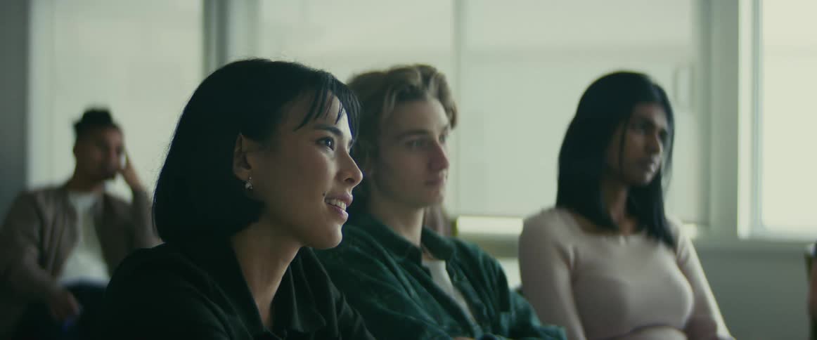 University students sitting on a classroom listening to the teacher