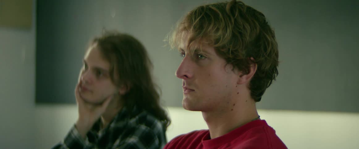 University students sitting on chairs in the classroom listening to the teacher