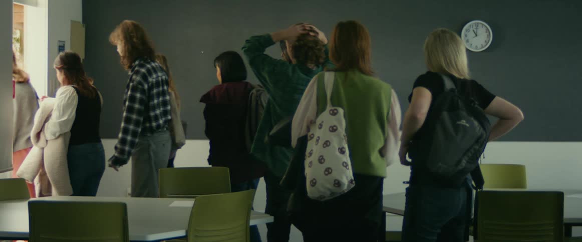 Students stand up and gather their items then leave a classroom