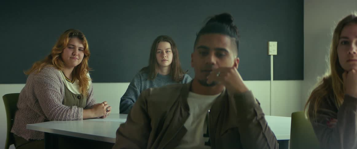 A group of university students in a classroom