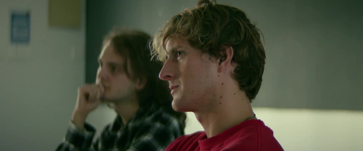 Two men sitting in the classroom listening to a class
