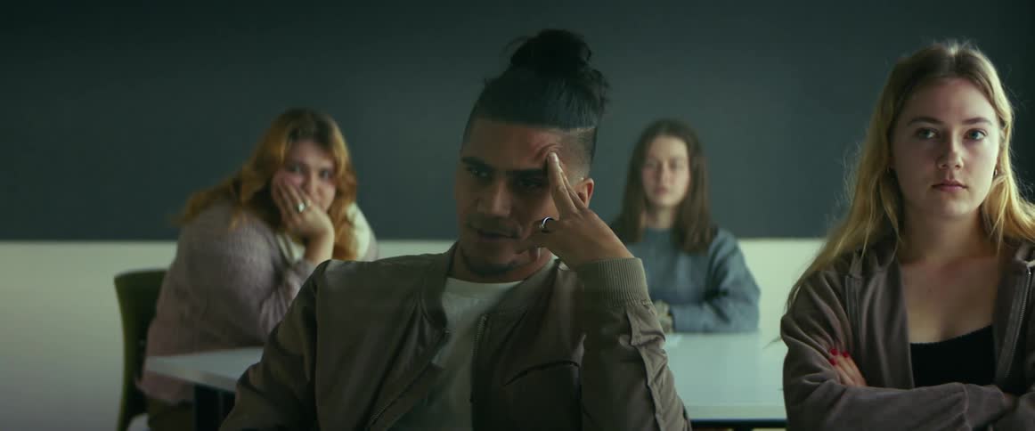 Bored looking male student looks into distance as equally bored female student turns to look in the same direction