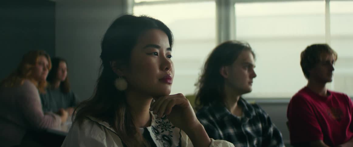 Students sit together listening in class