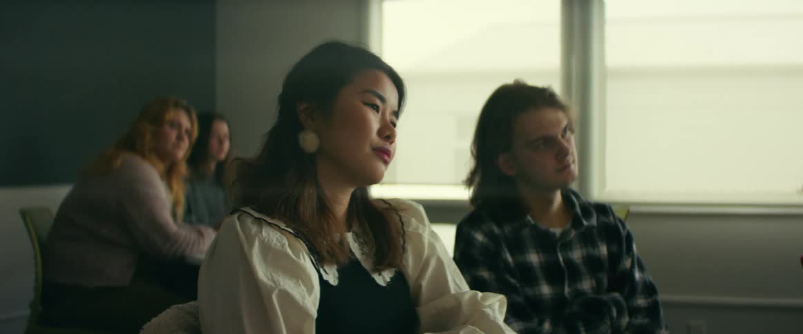 University students sitting on the classroom listening to a professor