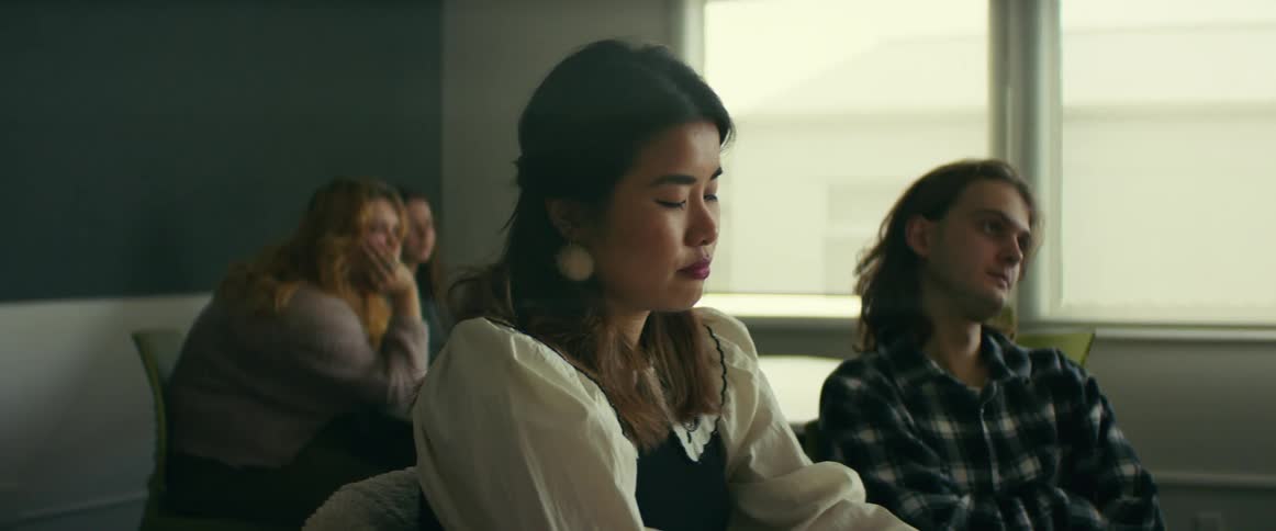 College students sitting at desks listen to professor giving lecture in class