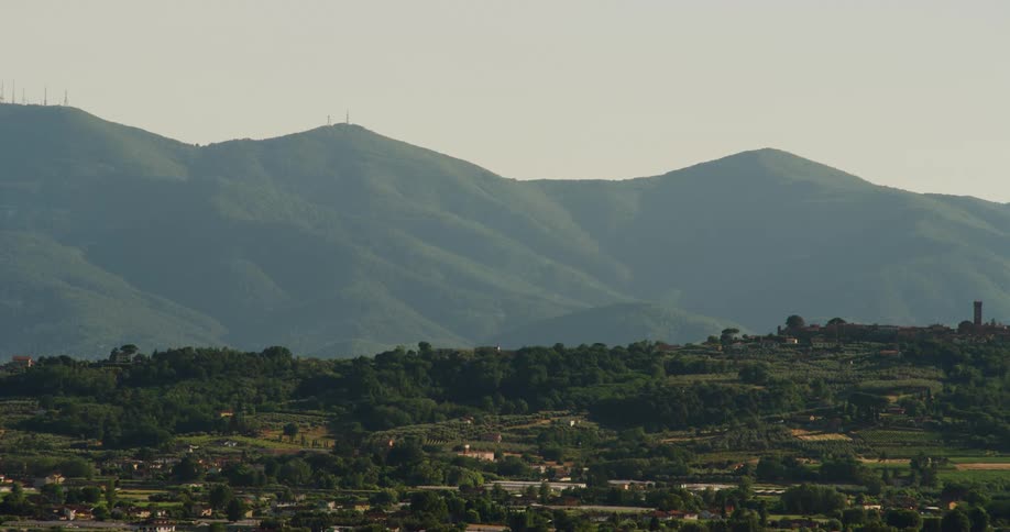 Buildings in a town with hills in the distance