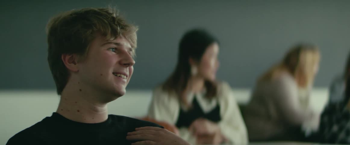 University student sitting on a chair in the classroom talking and laughing