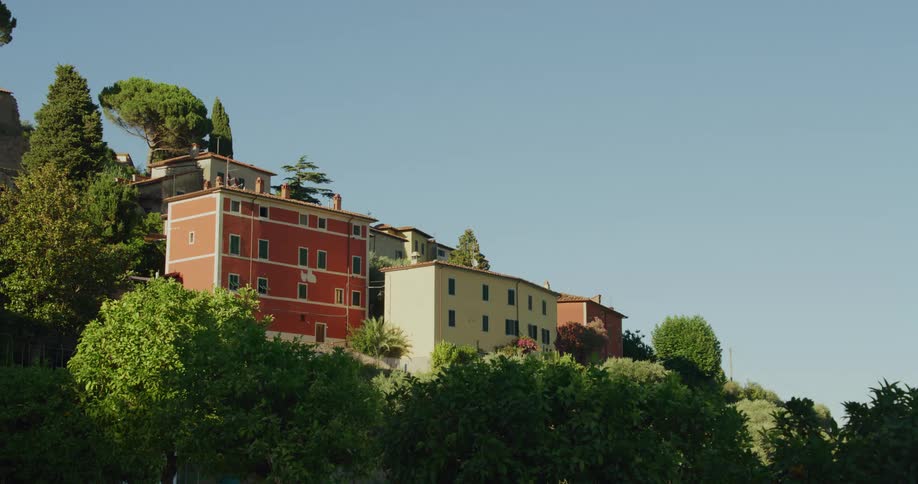 Colorful buildings on a villa on the top of a hill under a clear blue sky