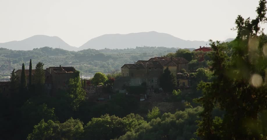 A series of homes built into a mountainous area covered in trees