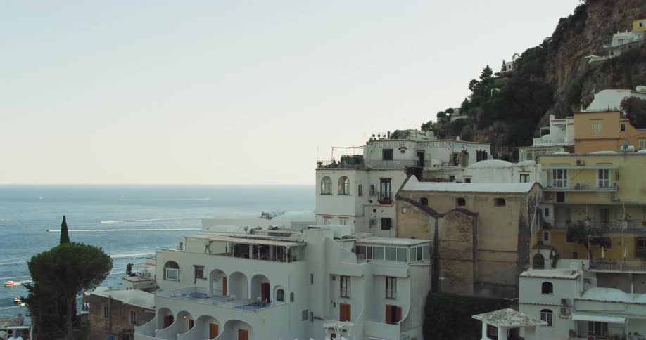 Village on the slopes of a mountain next to the ocean at morning