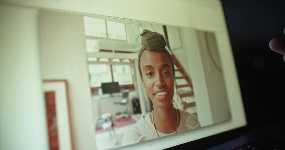 Extreme close up of a laptop screen during a video call with a woman