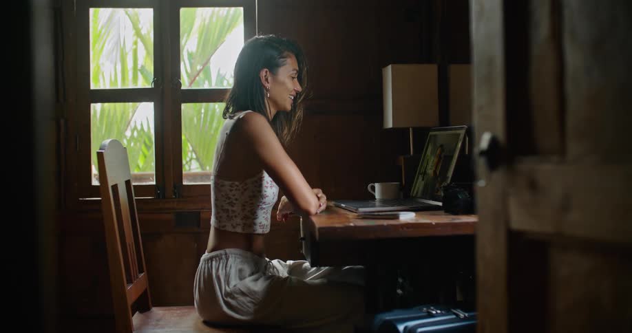 Woman engages in video call on her laptop