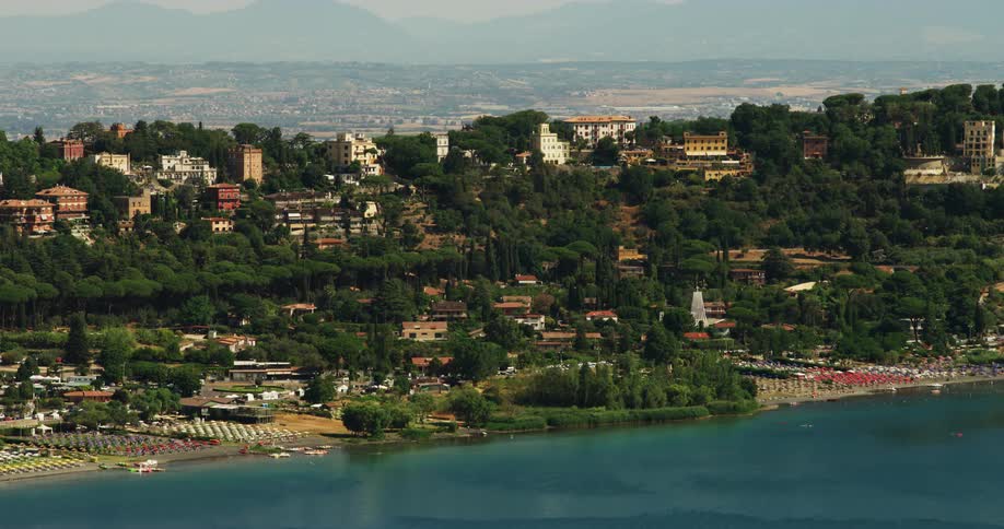Houses of a small town on the hills surrounded by thick lush green trees