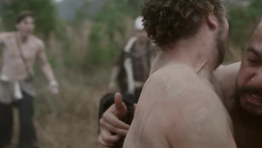 Men in medieval style outfits fighting in a field