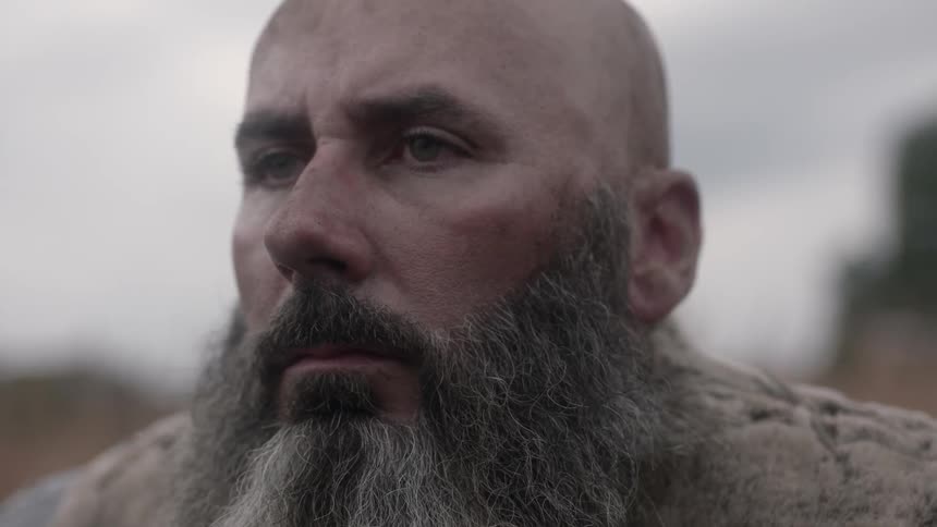 A man staring into the distance on an overcast day