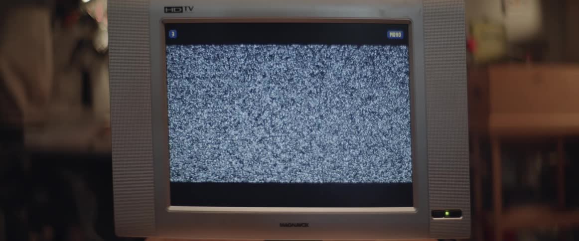 Static fills the screen of a television inside a room