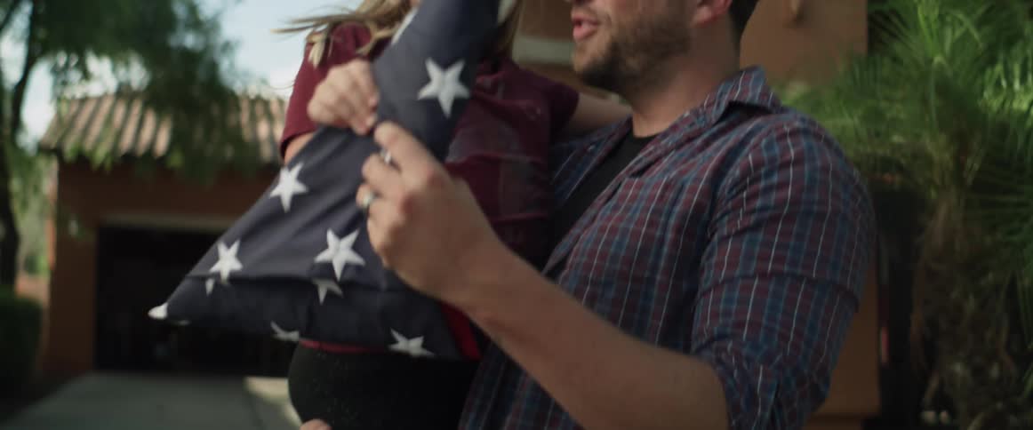 A father lifts his daughter into his arms