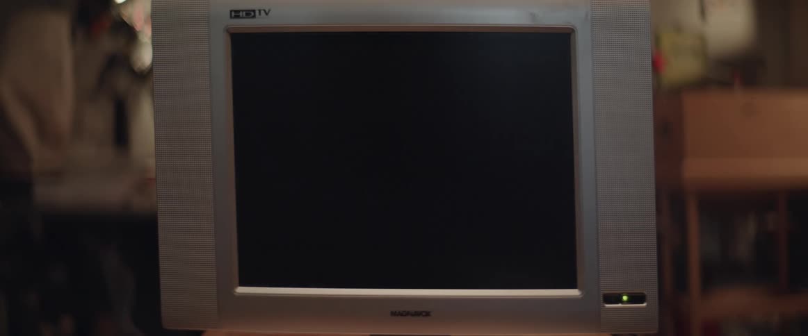 Static fills the screen of a television then it turns off and the screen is dark