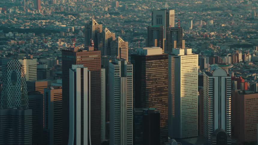 Skyscrapers tower over a neighborhood below in a congested city