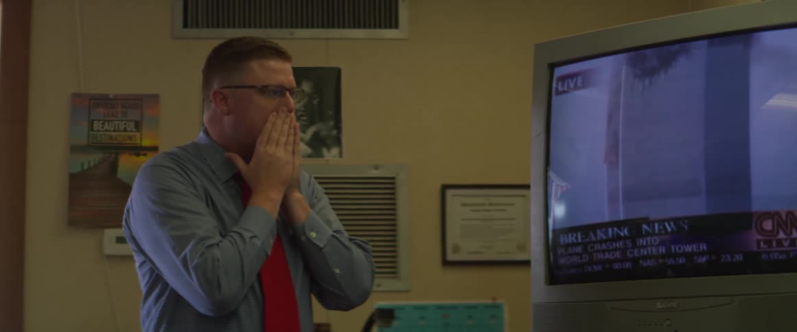 A man is in shock watching the buildings destroyed