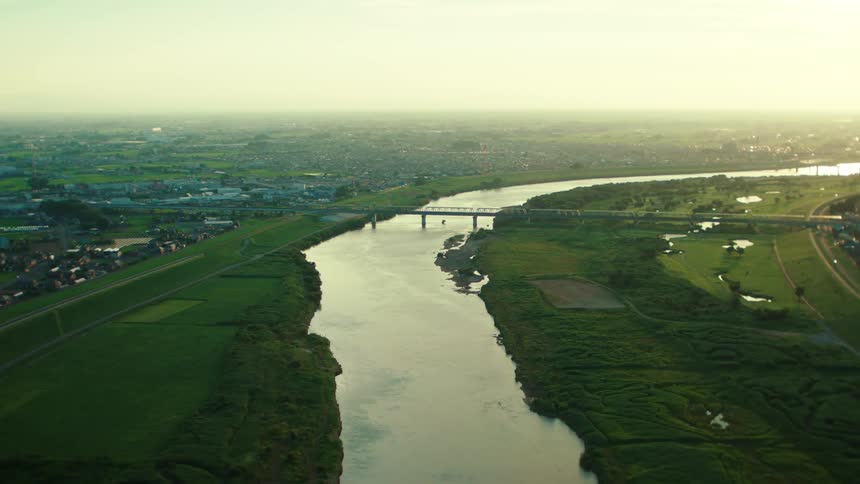 An aerial view of a river and buildings in a rural area