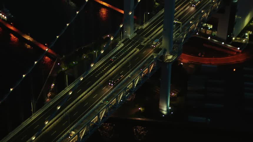 Heavy traffic passes over a bridge leading in and out of downtown