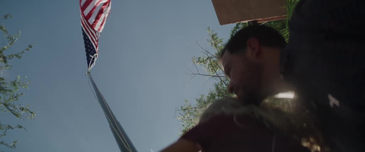 A father and daughter raise the flag together