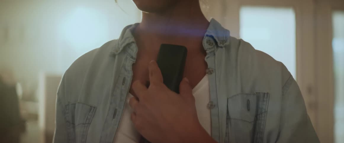 Shocked woman standing in the living room at home receives bad news on the phone