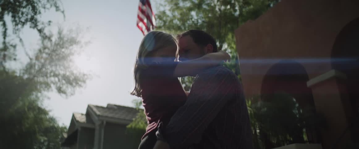 A father holds and hugs his daughter