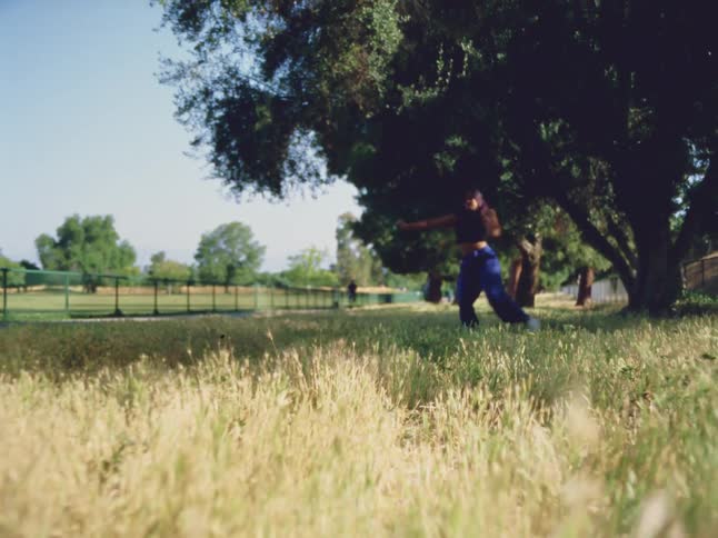 A woman is dancing in the grass