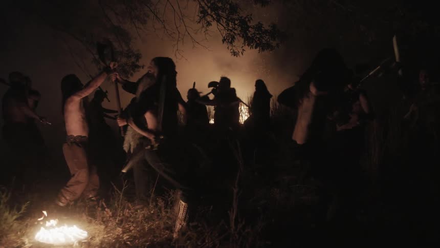 Fires are raging at night as people fight with weapons