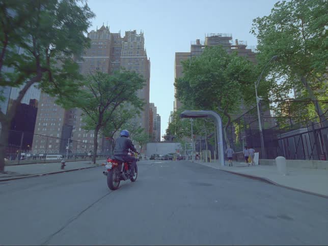 A man rides his motorcycle down the street