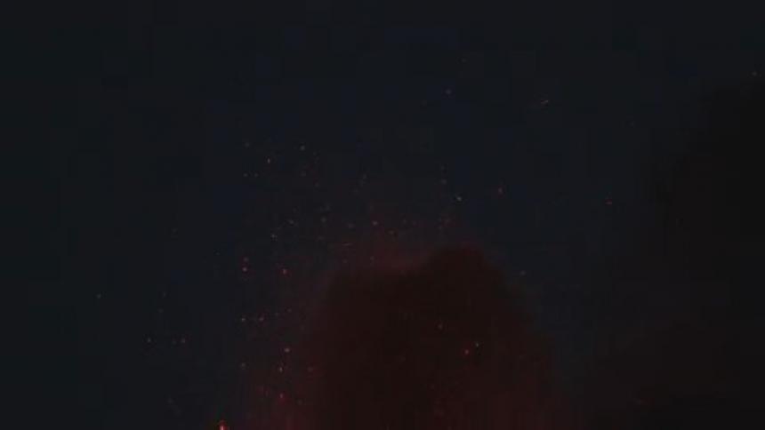 Smoke and sparks in the air as a fire burns
