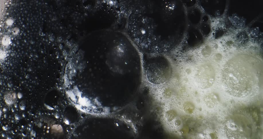 Bubbles are moving and breaking and one area has bubbles in foam