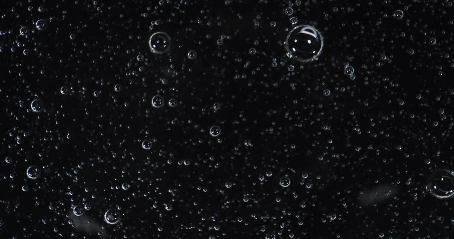 Orb spheres float in the darkness as light reflects on their surface
