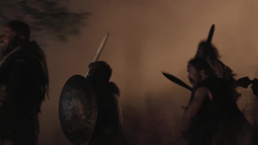 A group of people charge into battle at night
