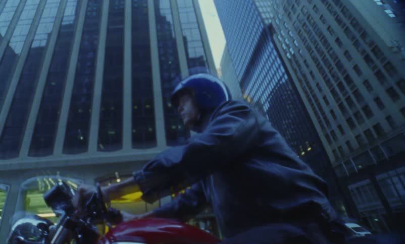 A person riding a motorcycle in a city