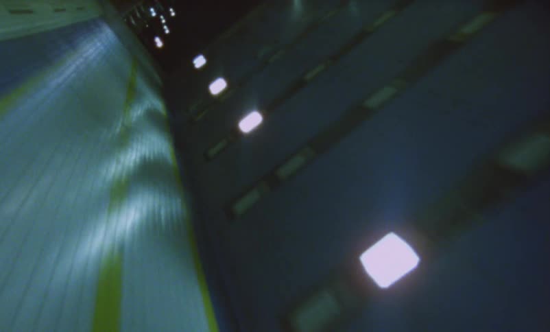 A tiled tunnel with overhead lights