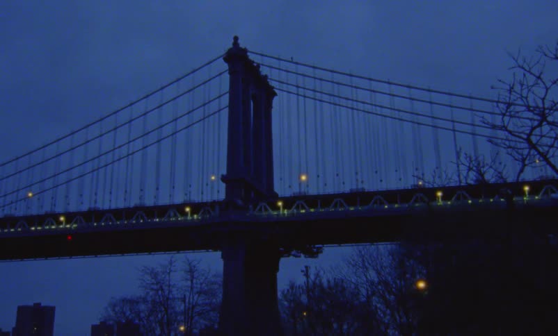 There are bunch of cars driving down a bridge