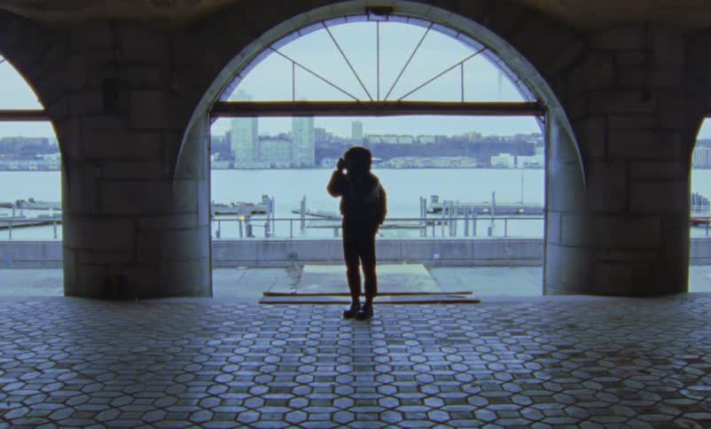 A woman is taking photographs by the water