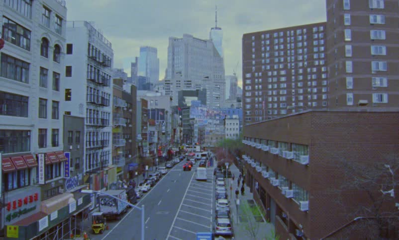 There is a view of cars driving down the downtown area