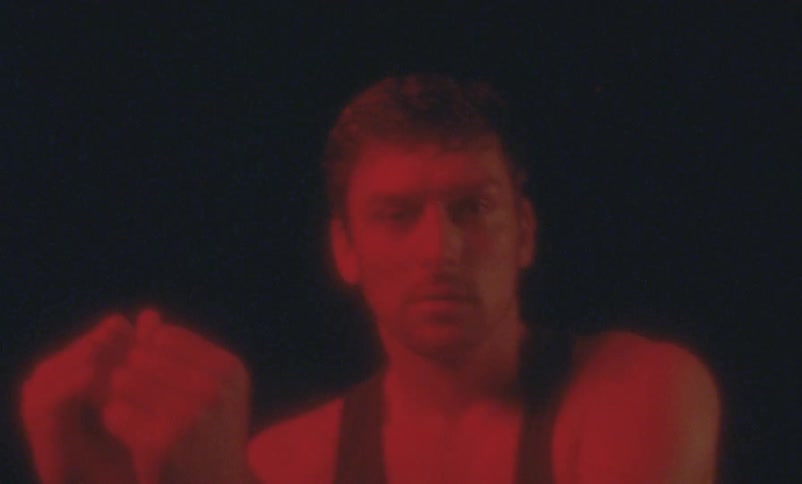 A man spins around and moves his arms while dancing