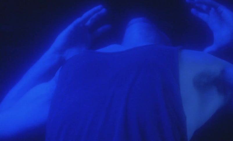 A man reaches his hands above his head and screams
