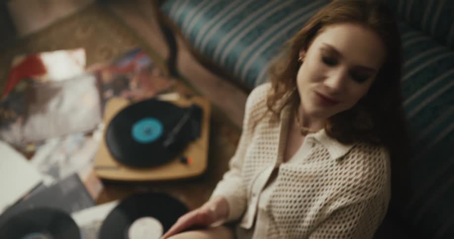 A woman is listening to records