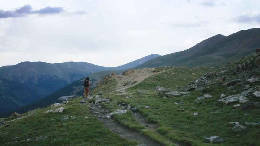 A view of a woman running on a trail