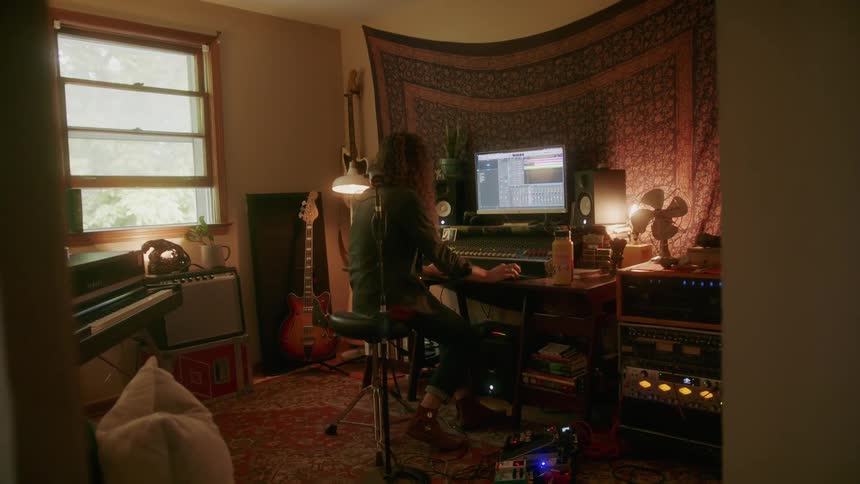 A man is working in his music studio