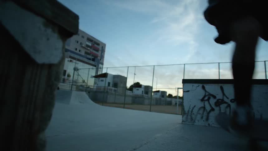 A man jumps on his skateboard in the park