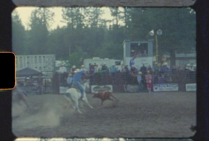 vintage rodeo footage of ropers chasing a cow in Montana shot on 8mm film